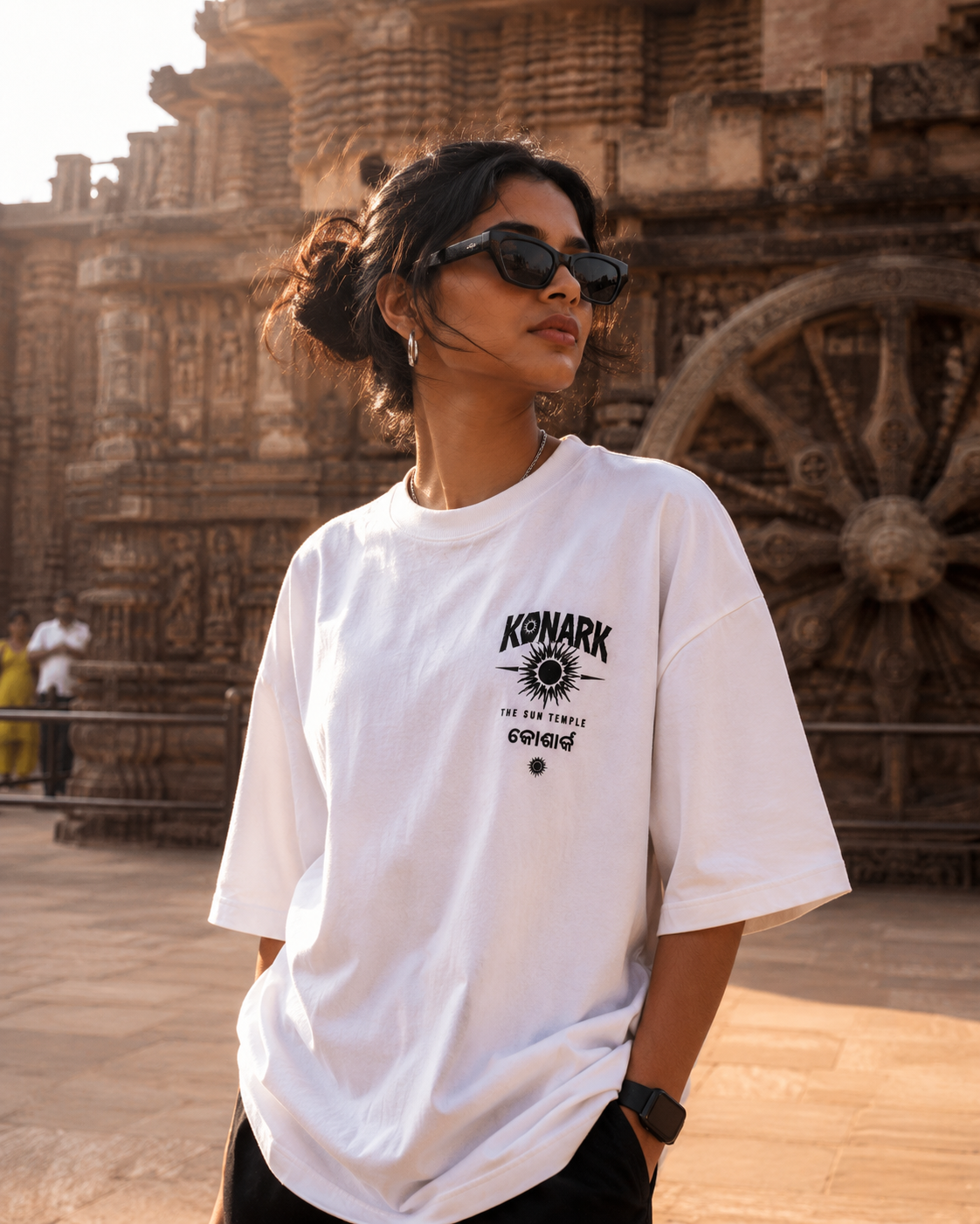 Konark oversized terry t-shirt in white, front chest print, worn by a model at the Konark Sun Temple